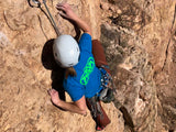Climber wearing blue and green Neon T-shirt