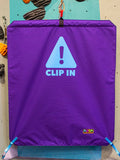 Purple belay gate reading CLIP IN by Neon Climbing Accessories.
