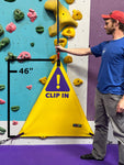 Yellow triangle belay gate by Neon Climbing shown as 46" tall size compared next to male climber.
